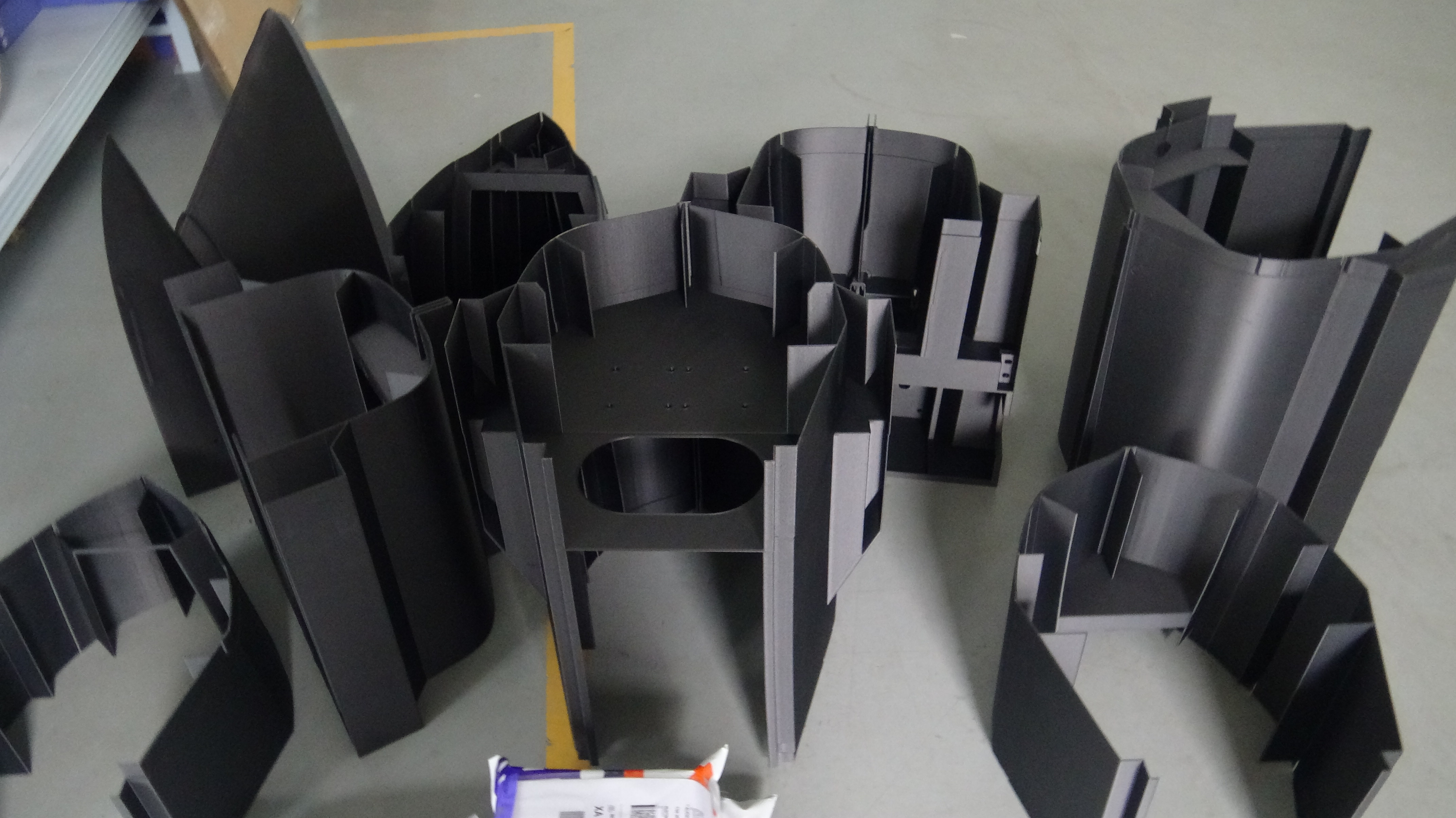All 7-8 submarine section prototypes printed, including mid-section hull, bow and stern flow guide structures, and internal frames, awaiting precise assembly